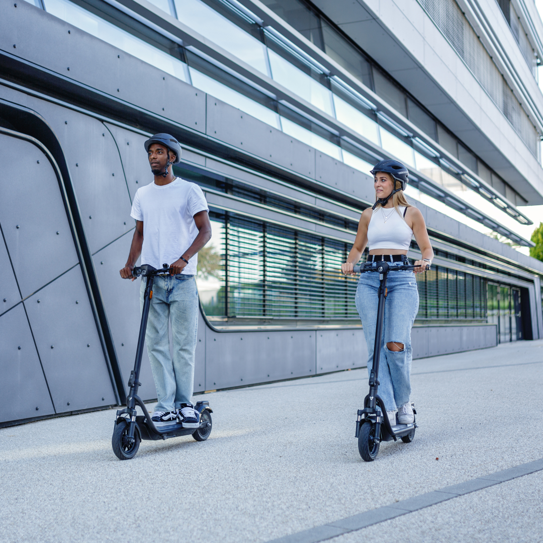Two NIU - KQi100F Electric KickScooter in action, on the road